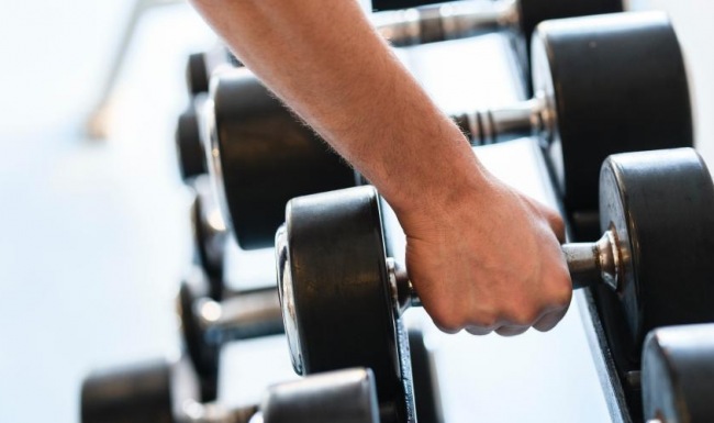 a close-up of a hand lifting weights