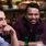 a couple of men sitting at a table with drinks