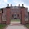 gated brick building with a driveway