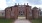 gated brick building with a driveway